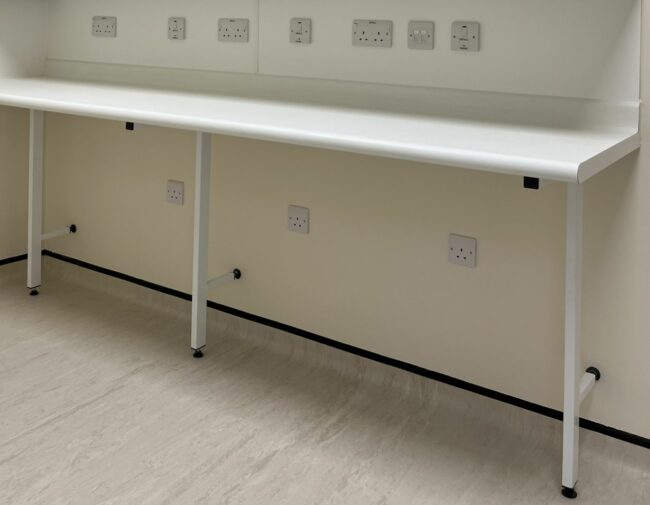 Standing height pharmacy countertop supported by cantilever legs