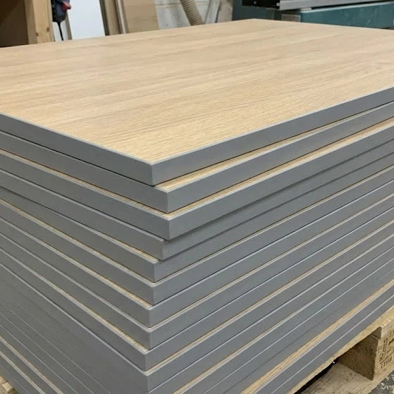 Stack of cut-to-size MFC panels with grey pvc edge and woodgrain melamine surface