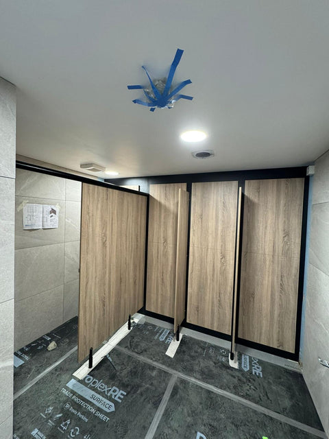 Ascent Range inline cubicle with woodgrain IPS panelling and dividers, during installation