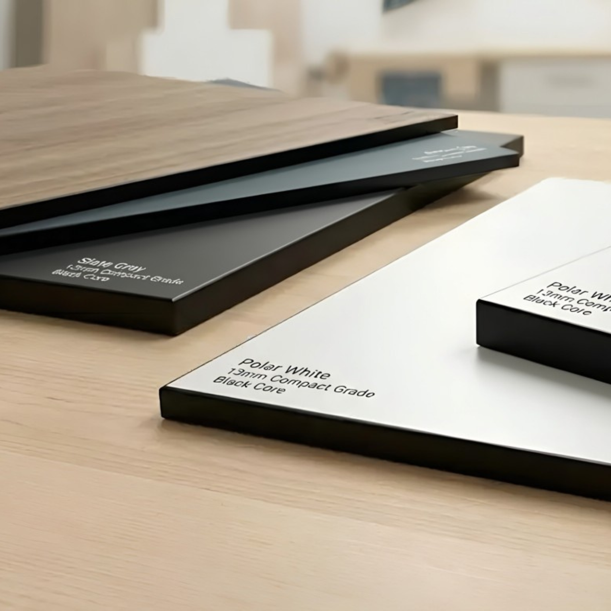 Stack of compact grade laminate panels with colour codes printed on