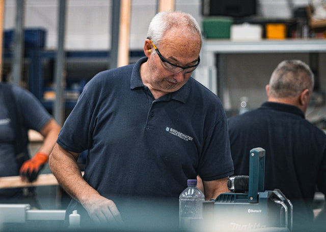 Assembling made-to-measure toilet cubicle components in Bolton