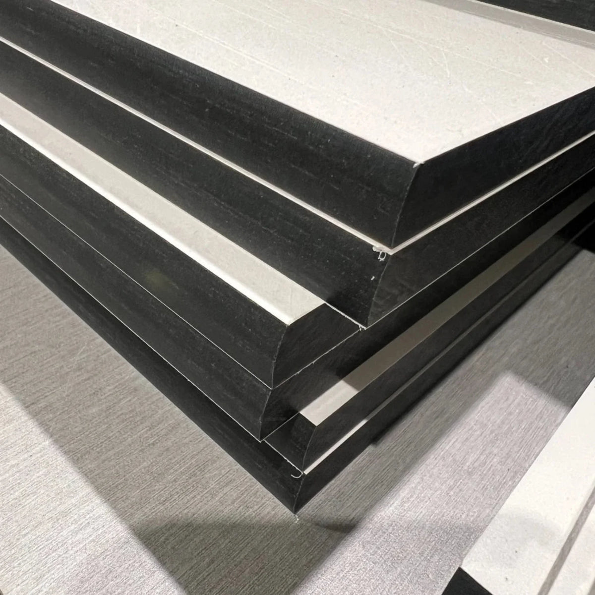 Stacked compact laminate worktops with CNC machined slight round edges and black core