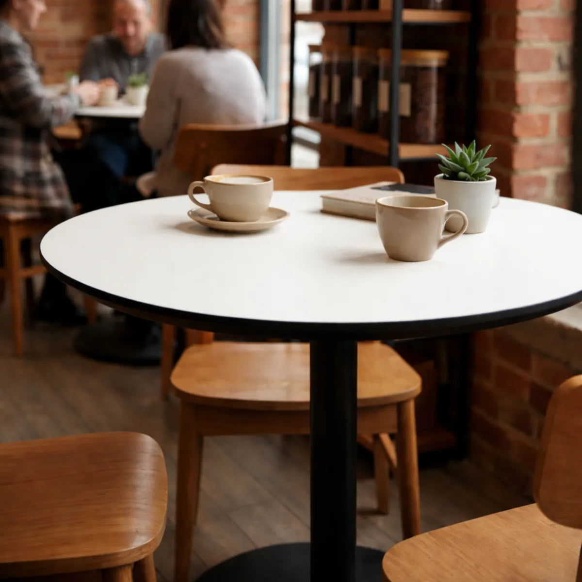 Round table with two coffee cups in a cozy cafe setting